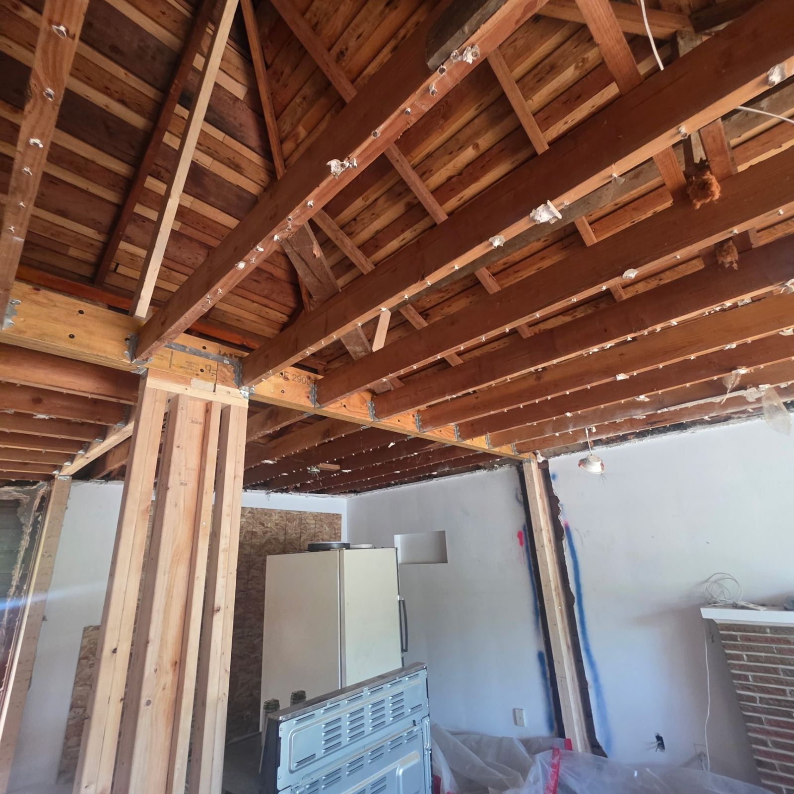 Exposed ceiling joists and new structural post during a remodel