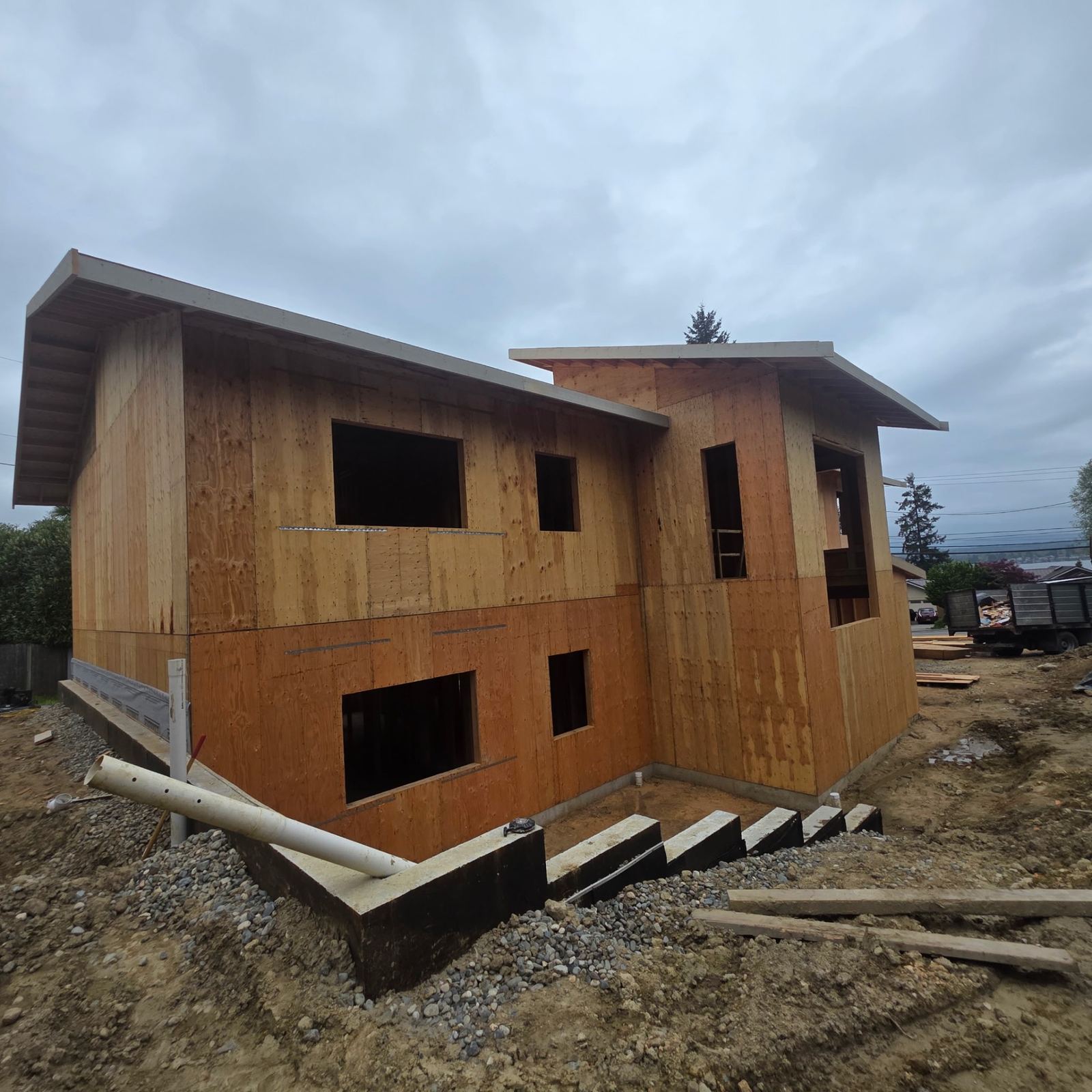 Two-story new construction home fully sheathed with window openings cut