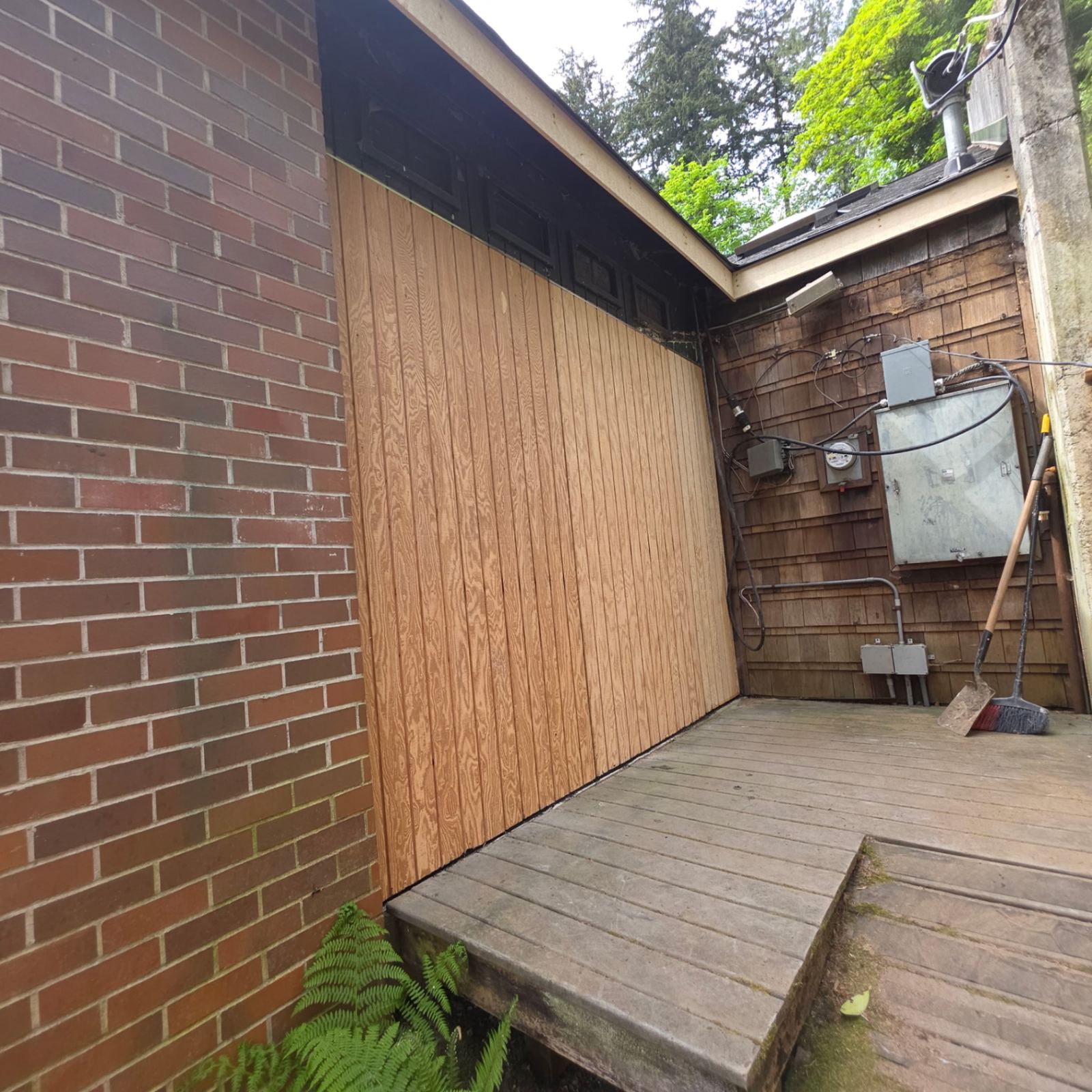 New exterior wall sheathing installed at a rebuilt garage wall