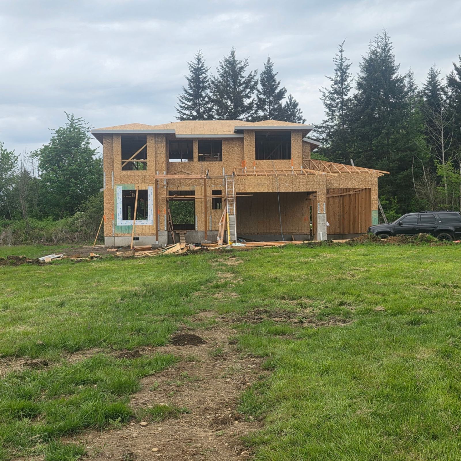 Two-story new construction home framed and sheathed on an open lot