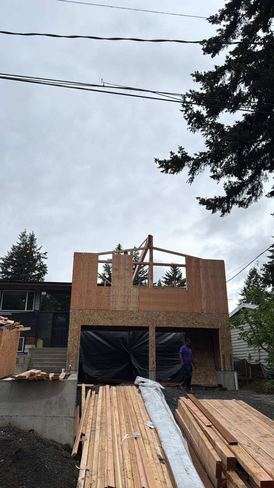 Second-story addition framed above an existing garage
